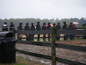 The equestrians are wet and cold