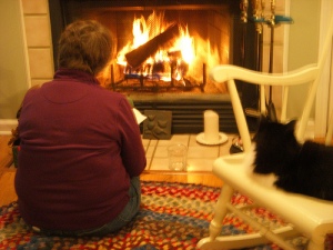 Mom and Sukey read in front of the fire